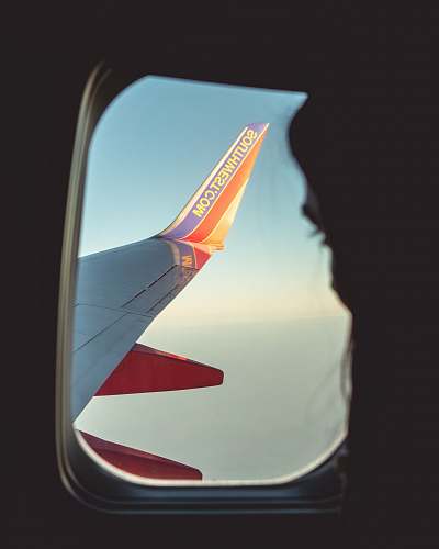 san francisco silhouette of person looking at airliner wing emblem